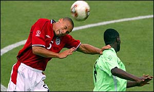 Rio Ferdinand (left) wins a header against Nigeria's 